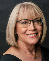 Headshot of Gail Burd wearing a black blouse and glasses.