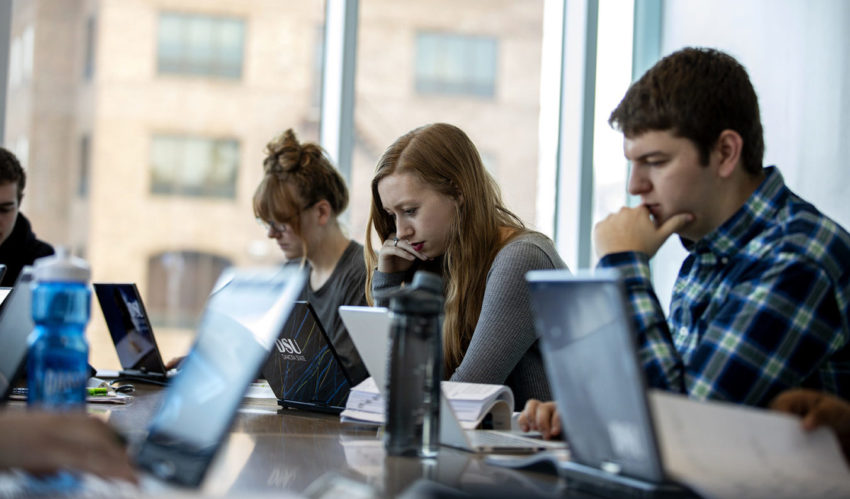 Dakota State University students working on laptop computers